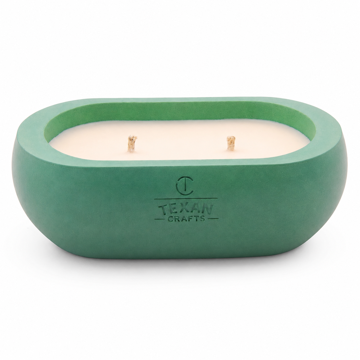 Alma Cedar Frost hand-cast stone soy candle — green vessel with embossed Texan Crafts mark, on white