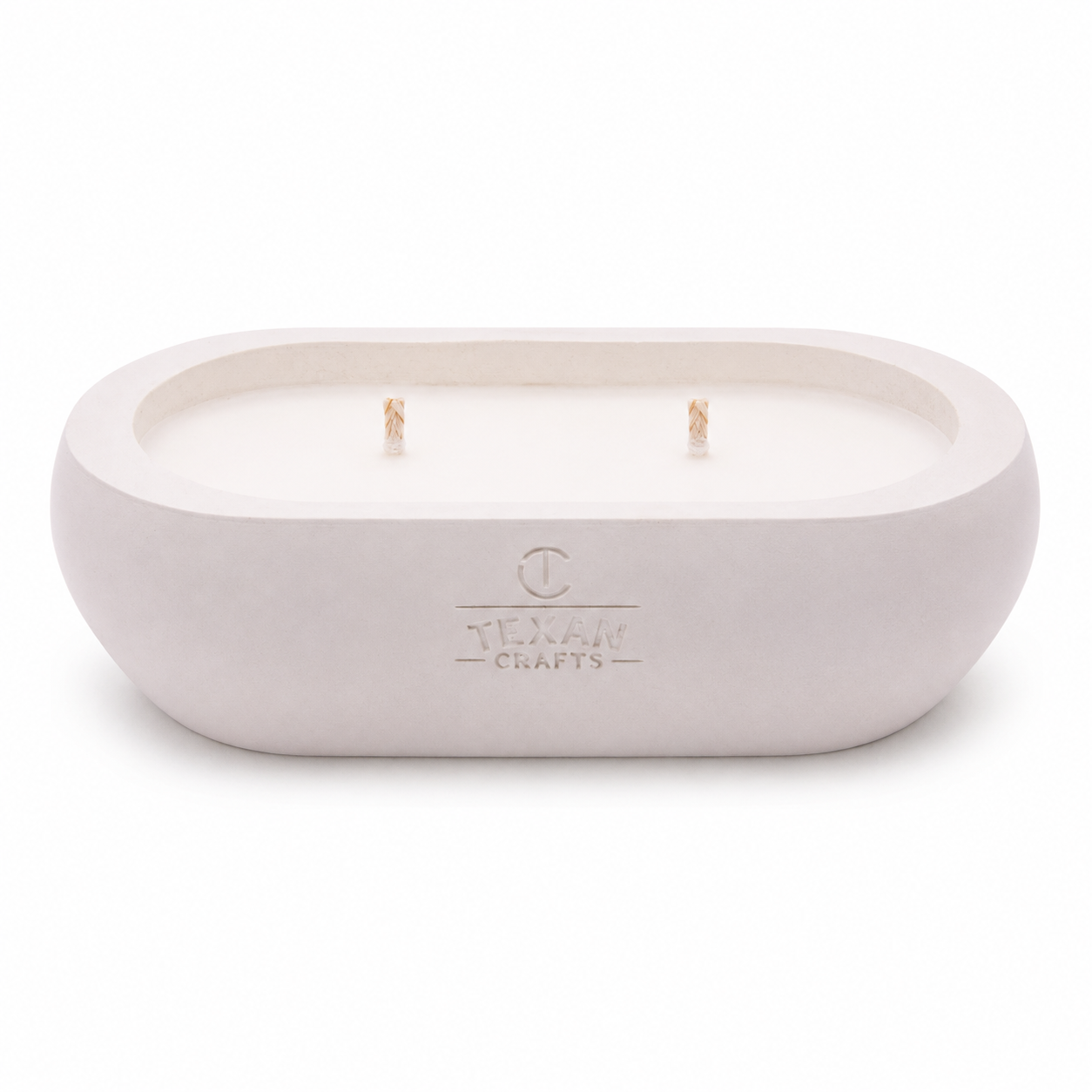 Alma Driftwood Cream hand-cast stone soy candle — pale cream vessel with embossed Texan Crafts mark, on white