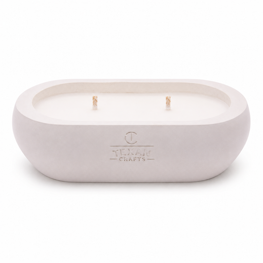 Alma Driftwood Cream hand-cast stone soy candle — pale cream vessel with embossed Texan Crafts mark, on white