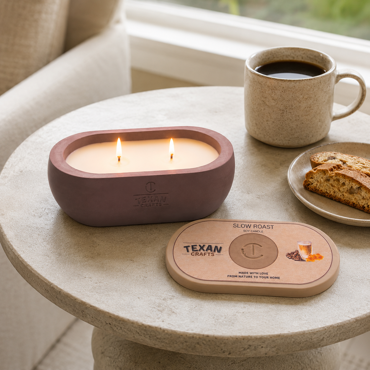 Alma Slow Roast hand-cast stone soy candle, lit and styled with coffee and biscotti — Texan Crafts