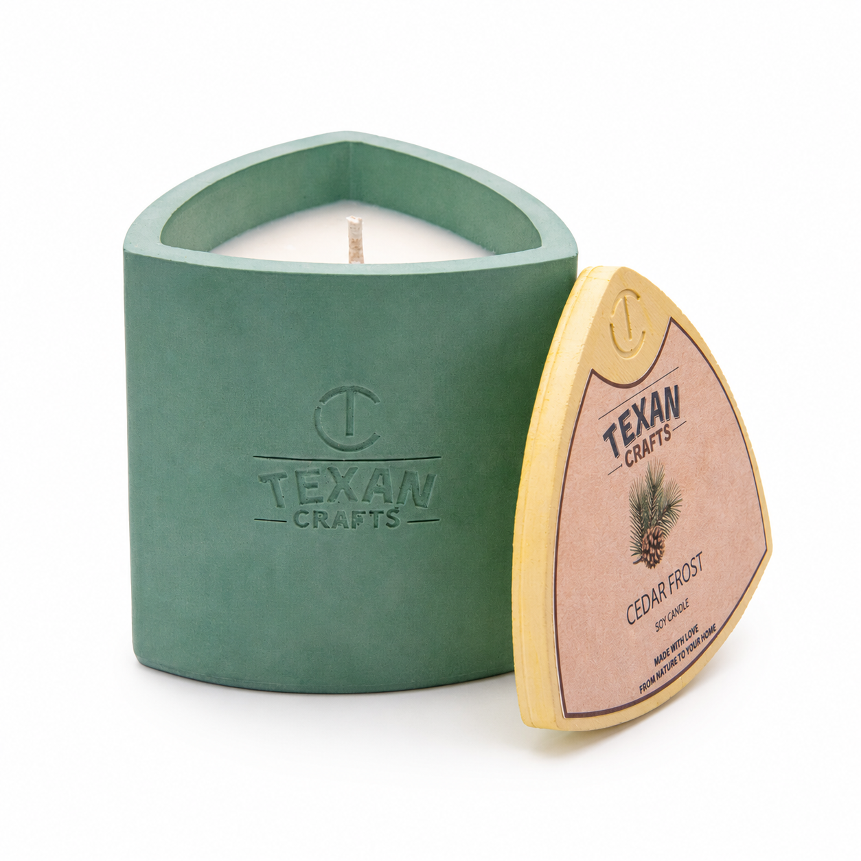 Mica Cedar Frost hand-cast stone soy candle — green vessel with embossed Texan Crafts mark, on white