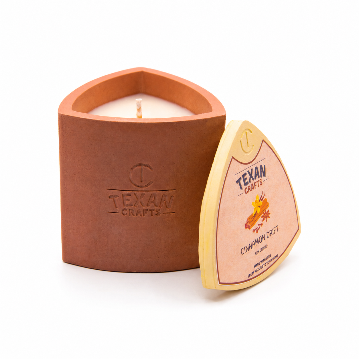 Mica Cinnamon Drift hand-cast stone soy candle — terracotta vessel with embossed Texan Crafts mark, on white